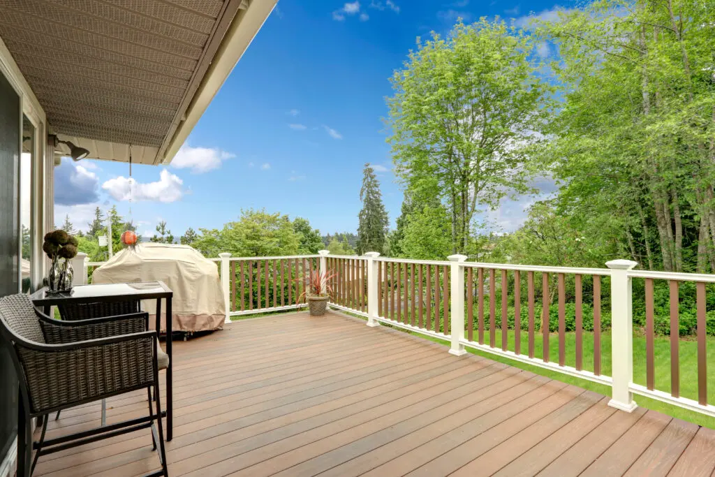 A deck with chairs and tables on it from a custom deck builder in Kennesaw, GA